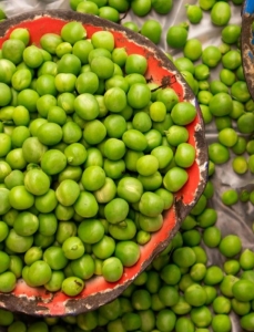 A flat lay of fresh peas in bowls