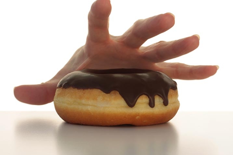 hand reaching for a donut