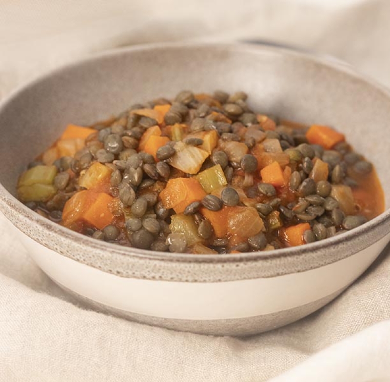 bowl of French lentil stew on white cloth